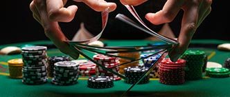 poker table, casino chips, dealer shuffling cards