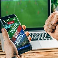 placing a sports bet online, mobile, laptop, 